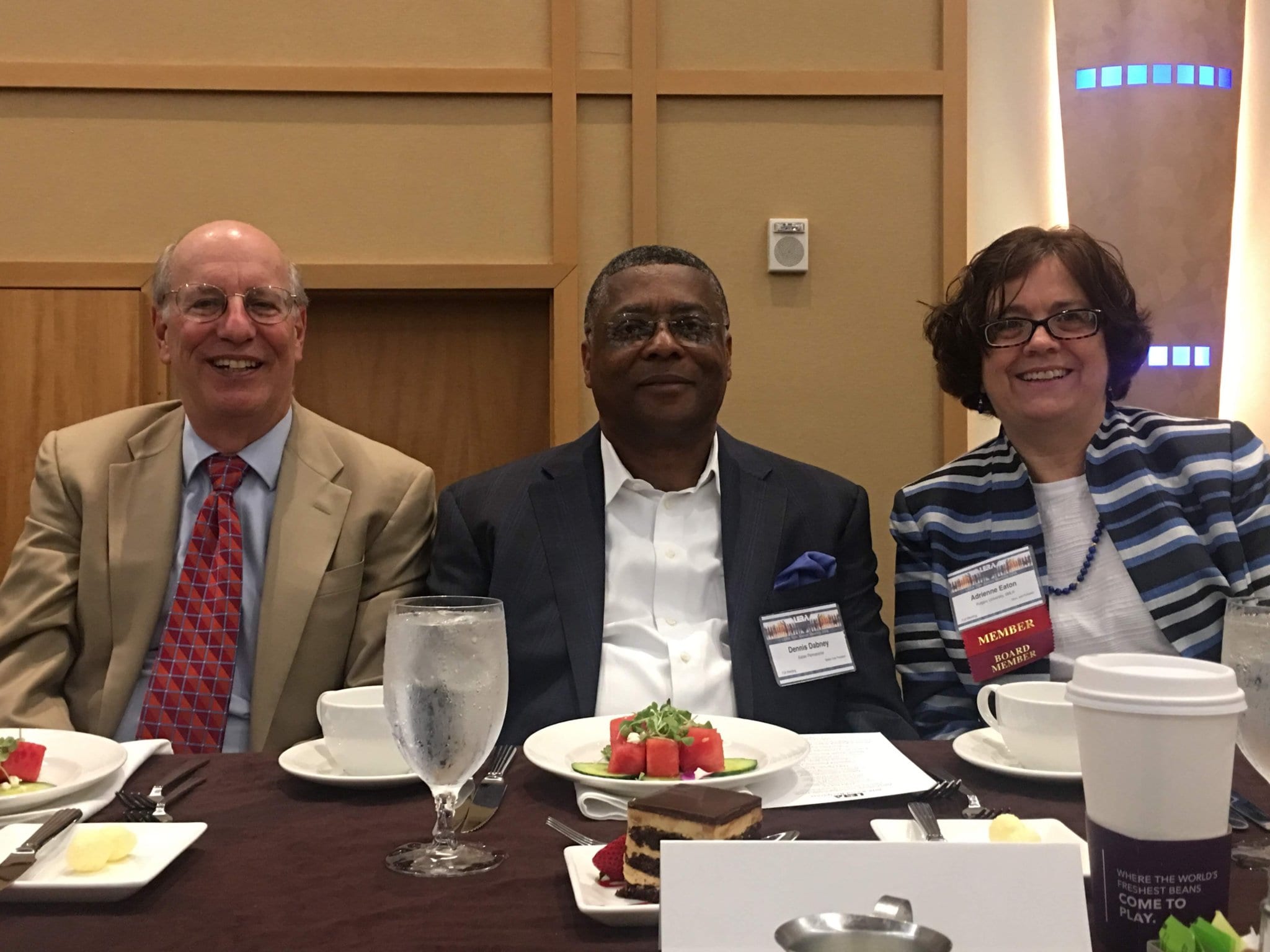 Dennis Dabney seated at a table with two colleagues