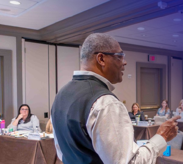 Dennis Dabney leading a workshop in a conference room